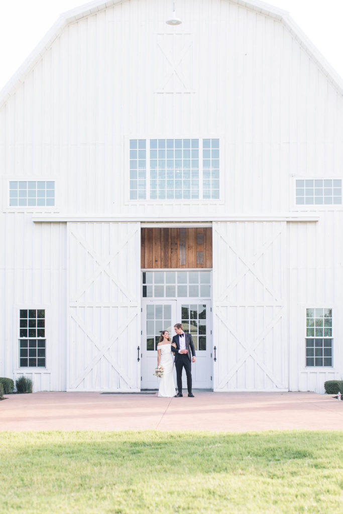 Couple portrait in front of White Sparrow Barn